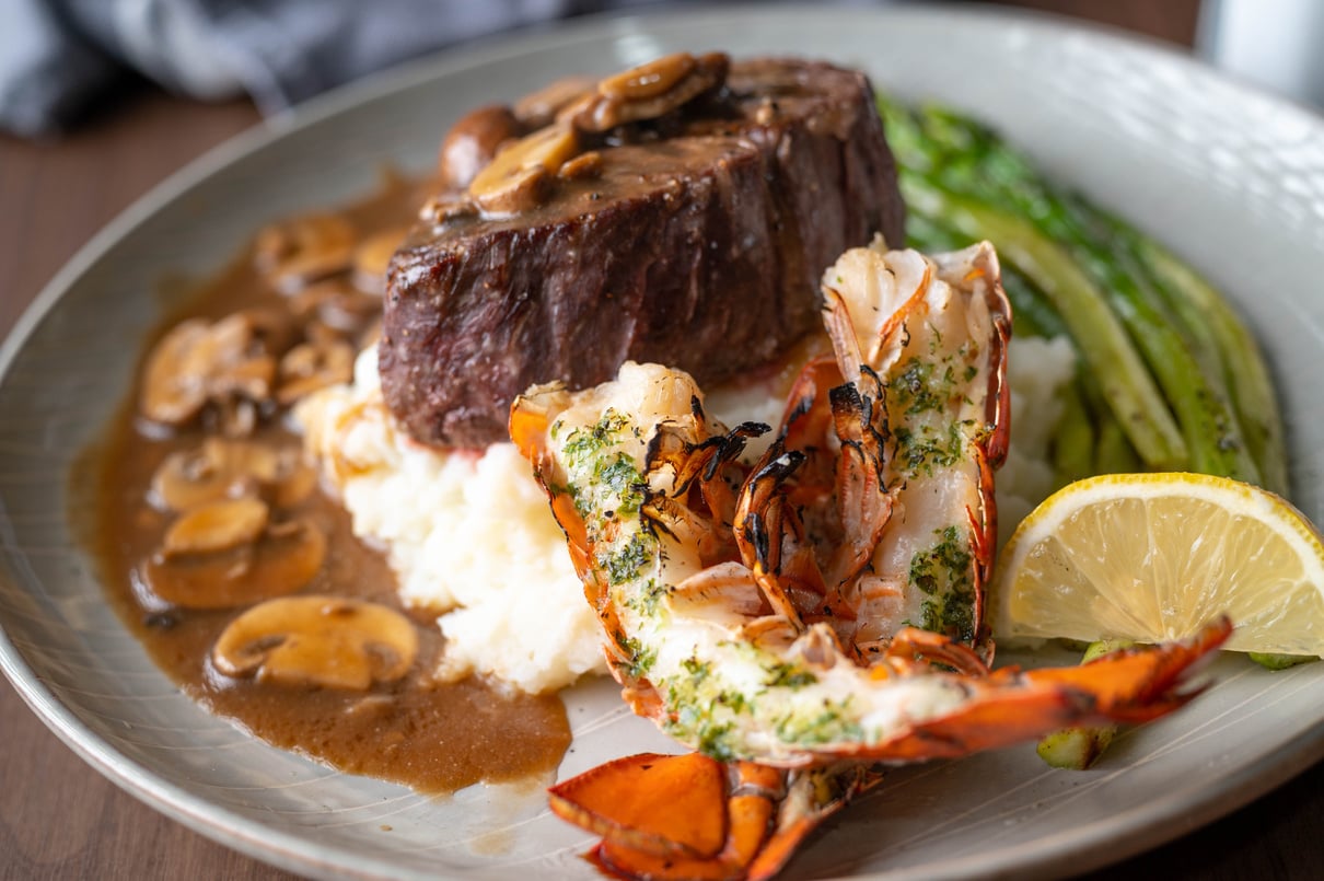 surf and turf, lobster tail and tenderlon steak with mushroom gravy sauce